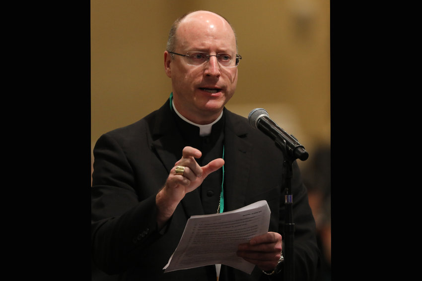 Bishop W. Shawn McKnight of Jefferson City, Mo., speaks from the floor on the first day of the spring general assembly of the U.S. Conference of Catholic Bishops in Baltimore June 11, 2019.