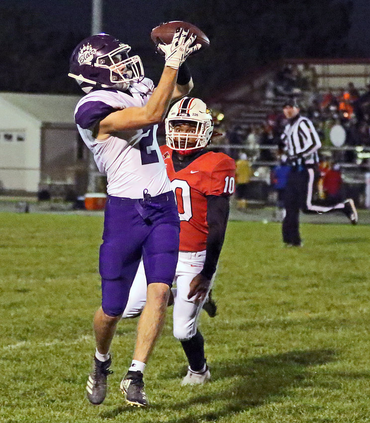 Blair senior Conner O'Neil hauls in a pass in front of a Cardinals defender Friday at South Sioux City.