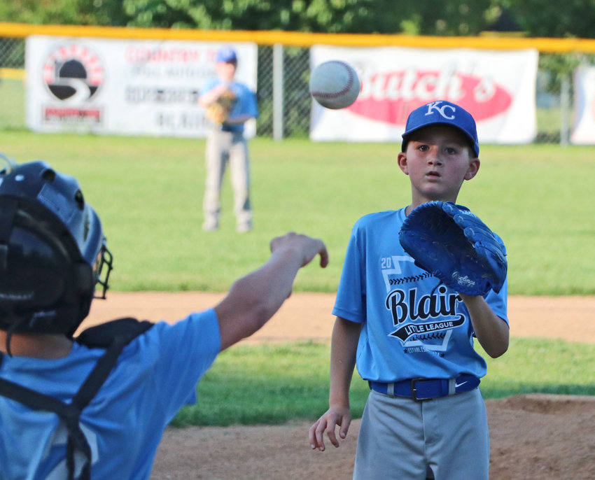 Blair Little League Royals pitcher Blayton Anderson, facing, catches a throw back to the mound by his catcher, Aiden Flynn, on July 1 at Wederquist Field.