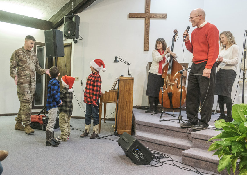 Blair police officer Tom Byrne attended the Stangl and Kopsa Christmas concert Dec. 22 at Abiding Faith Baptist Church, surprising his children upon his return from deployment in Jordan.