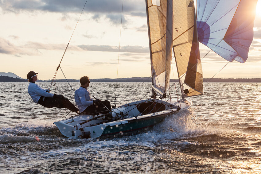 Rowan Yerxa, left, and Lee Laney sailing at sunset on Bellingham Bay. Brandon Sawaya photo. 