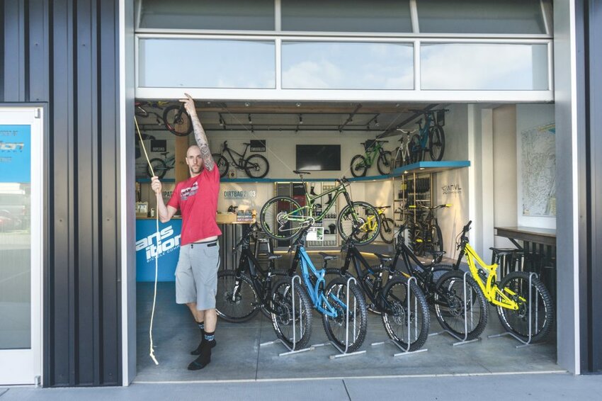 Kevin Menard, co-founder of Transition Bikes opens the door on the company's new showroom at 1600 Carolina St., in Bellingham, Photo by Anne Cleary