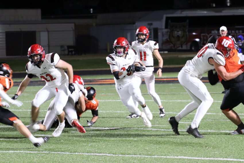 Brookings running back Ben Schulte carries the ball during the opening half of a Class 11AA playoff game against Huron on Thursday at Tiger Stadium.