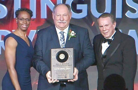 Dave Huff, middle, receives the NIAAA&rsquo;s Bruce D. Whitehead Distinguished Service Award from NIAAA President Dr. Lisa Langston, left, and Executive Director Dr. Mike Blackburn, right.