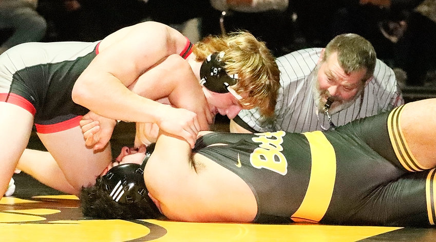 With former North Scott wrestler and coach Clint Long on the call, Lancer junior AJ Petersen shows the lights to Bettendorf's Diego Cortes in their 220-pound match Thursday night.