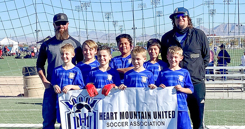 The Heart Mountain 10U team poses with a banner at the Las Vegas Thanksgiving Classic. Pictured from left are, back row: Coach Chad Curtis, Braeden Curtis, Kenny Parker, Kolbie Parker and Coach Travis Rapp, and front row: Pael&eacute; Rapp, Cristiano D&rsquo;Allessandro, Liam Wolford and Cyrus Graham. The United team went 2-2 during their first experience at a large tournament outside of the state.