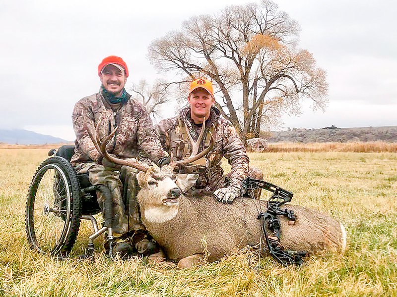Dan Jordan and his hunting mentor from Wyoming Disabled Hunters, Scott Smith, pose with Jordan&rsquo;s mule deer buck after a successful hunt last fall. The group is now accepting applications for the 2022 season &mdash; and looking for volunteers to help out with hunts.