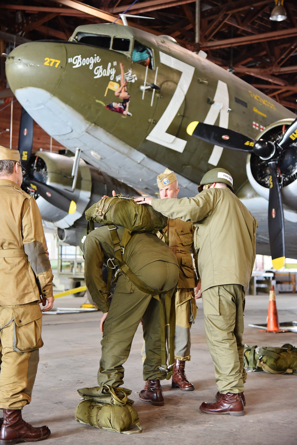 Students learn how to don a parachute during a recent jump school hosted by the WWII Airborne Demonstration Team.