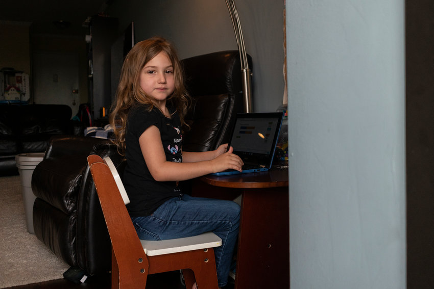 Norah, 5, a P.S. 81 student, looks out of her balcony window next to the remote learning station her parents made. She&rsquo;s starting kindergarten remotely this year, as in-person classes have been delayed for elementary schools until at least Sept. 29.