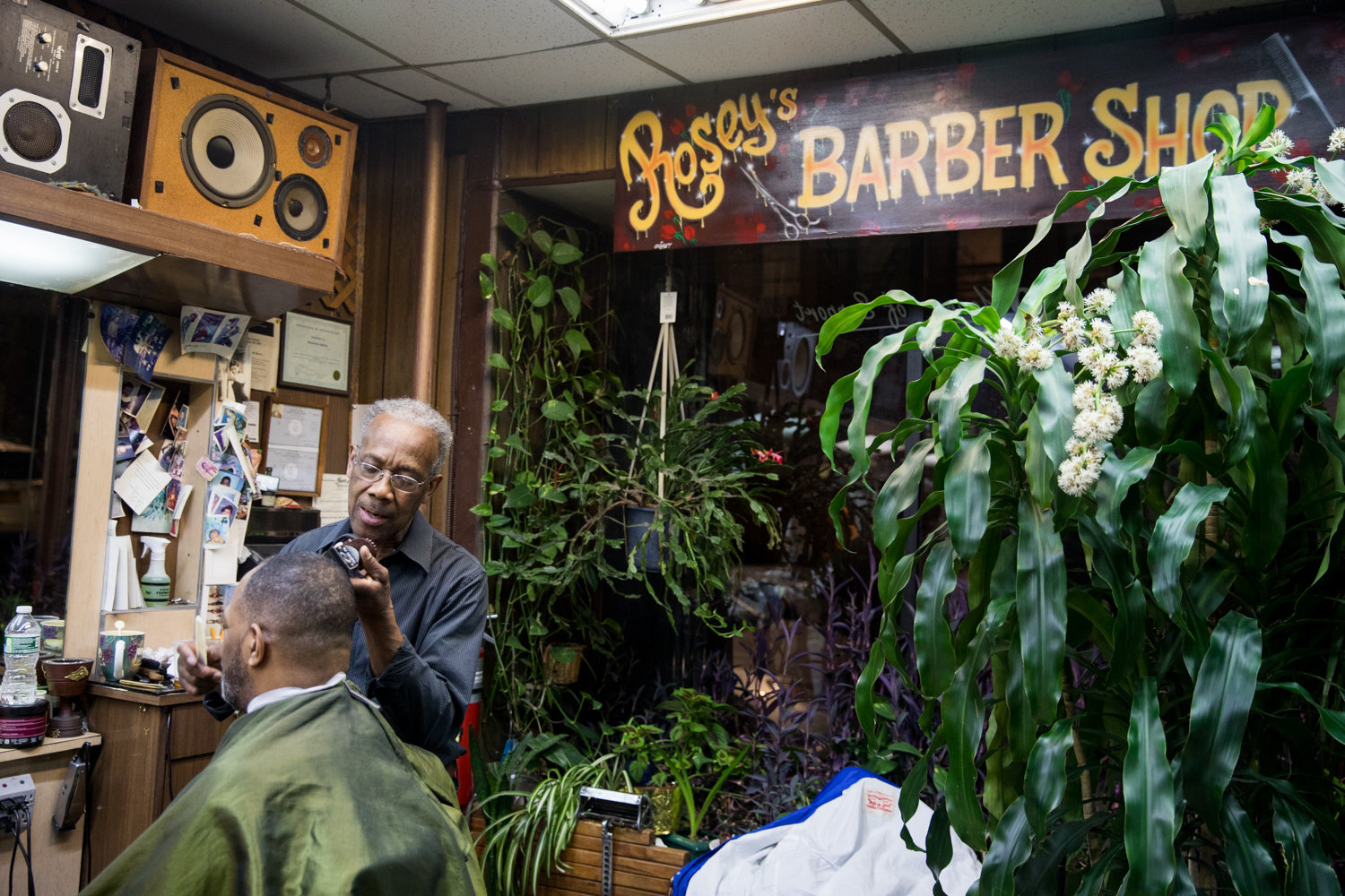 Roosevelt Spivey shaves J. Loren Russell’s hair in Marble Hill’s International Unisex Salon, known to patrons as Rosey’s Barber Shop. Spivey’s salon is facing an uncertain future after learning his shop rent is jumping $1,500 a month.