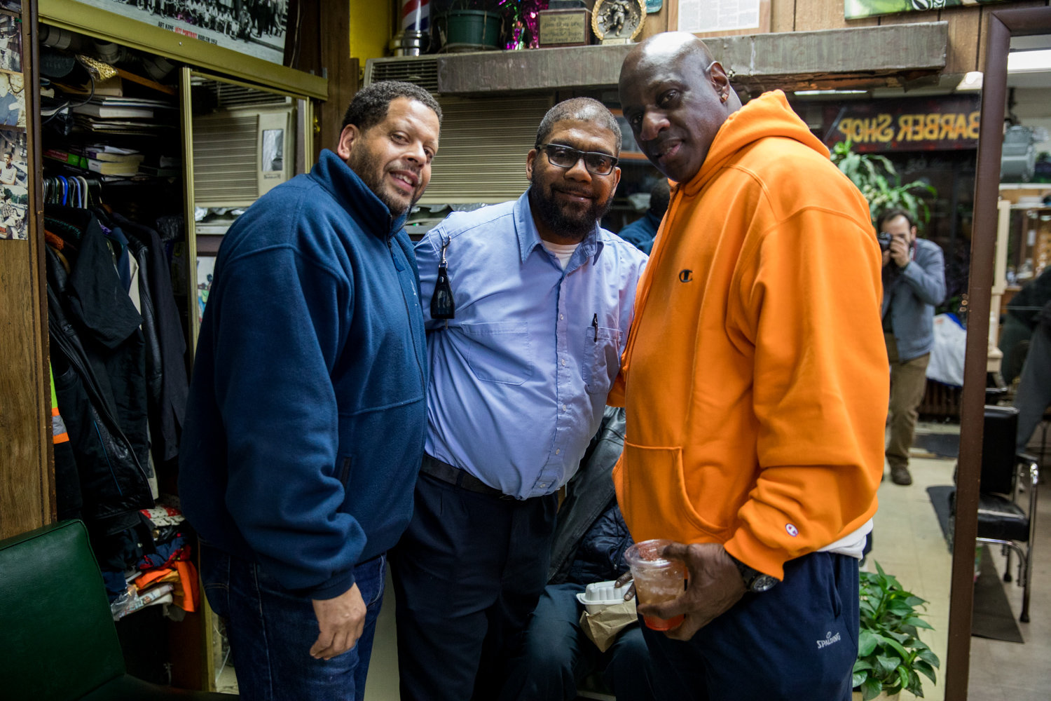 Walter Watson, center, smiles with Scott Dread and Cornell Colton inside Marble Hill’s International Unisex Salon on March 6. Watson died of complications related to COVID-19 on May 4. He was 55.