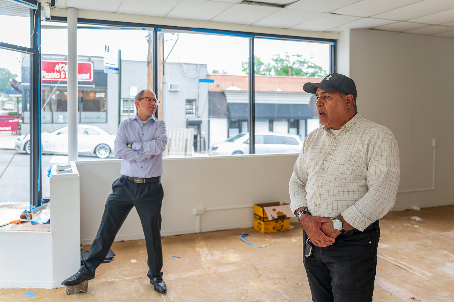 Real estate broker Michael Gilbert, left, and agent Epifanio Vargas found a buyer for 6050 Riverdale Ave., after listing it on the market for just three days. Generally such listings — especially those above $1 million — will sit on the market for months.
