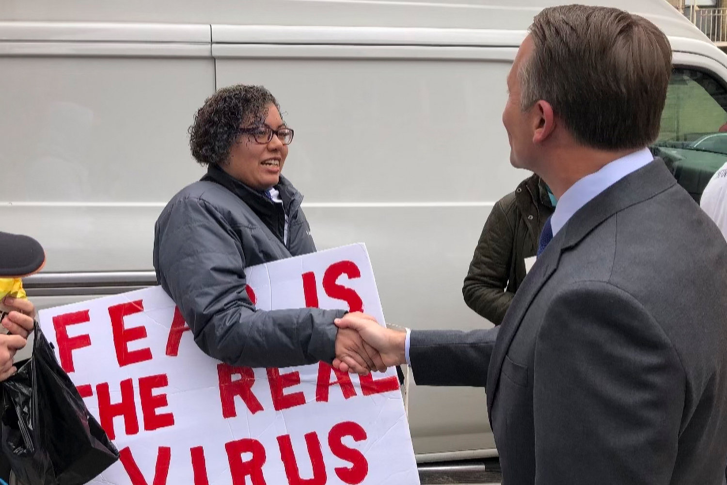 Republican gubernatorial candidate Rob Astorino shakes hands with an anti-vaccine mandate protester who is said to have later held up a sign displaying a swastika during a rally held outside Assemblyman Jeffrey Dinowitz’s office on Kingsbridge Avenue. Astorino claims he didn’t see the sign when he met the woman there, and added he’s just as upset about its usage there as Dinowitz was.