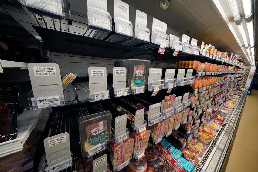 EMPTY SHELVES &mdash; A display of lunch meats is partially empty at at a market in Pittsburgh on Tuesday. Shortages at U.S. grocery stores have grown more acute in recent weeks as new problems &mdash; like the fast-spreading omicron variant and severe weather &mdash; have piled on.
