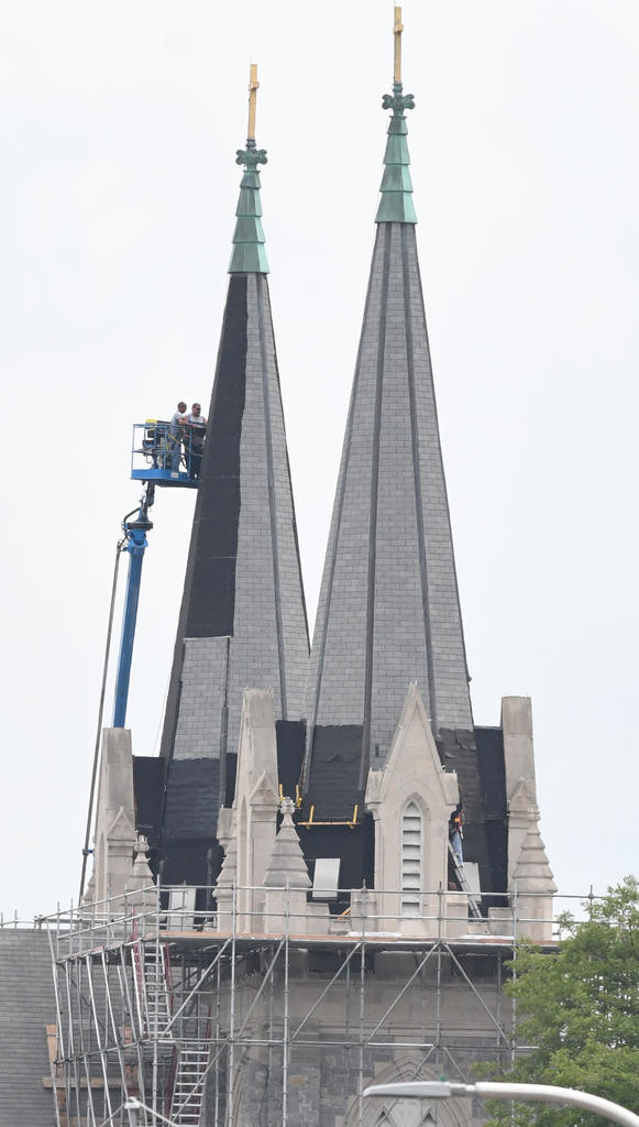 ROOFING WORK - Roof and bell tower areas are undergoing construction Thursday at Holy Trinity Roman Catholic Church, 1206 Lincoln Ave.  in Utica.  (Sentinel photo by John Clifford)