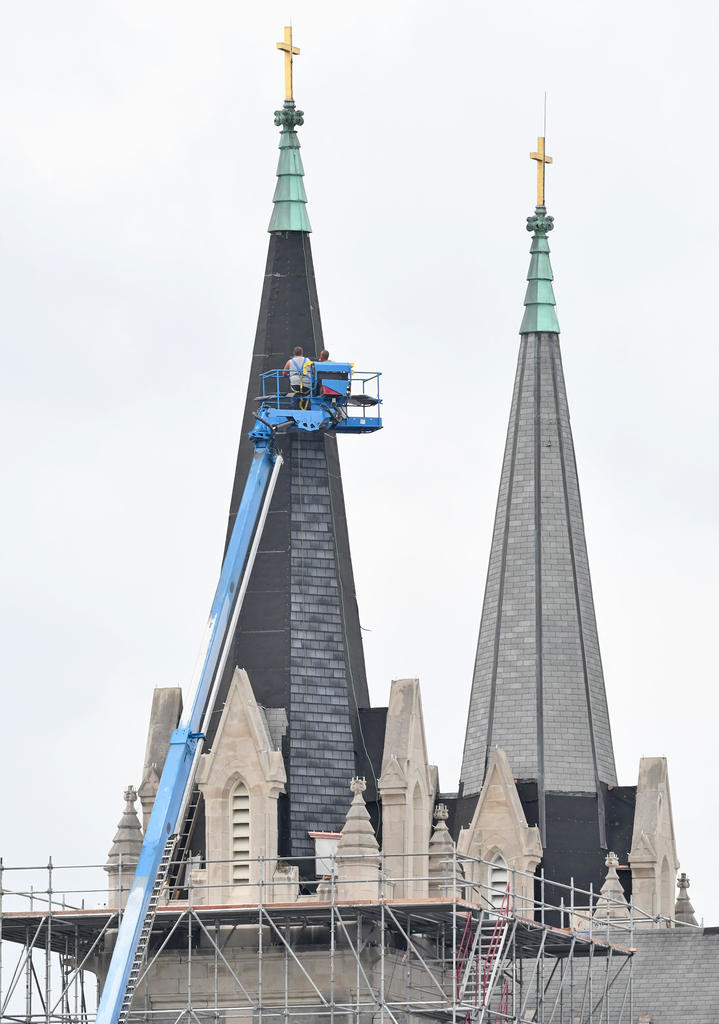 KEYBOARD WORK - Roof and bell tower areas are undergoing construction Thursday at Holy Trinity Roman Catholic Church, 1206 Lincoln Ave.  in Utica.  (Sentinel photo by John Clifford)