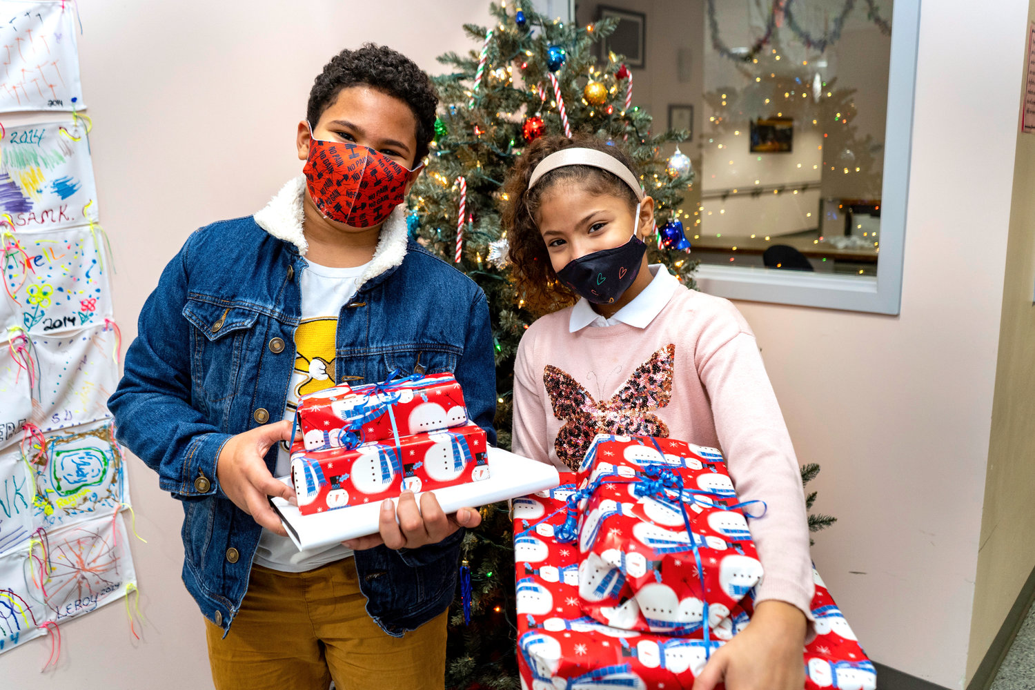 HAPPY SURPRISE — Jackob and Rebeca Benitez-Sanquiche can hardly contain the excitement in anticipation of opening presents from their special secret Santas.