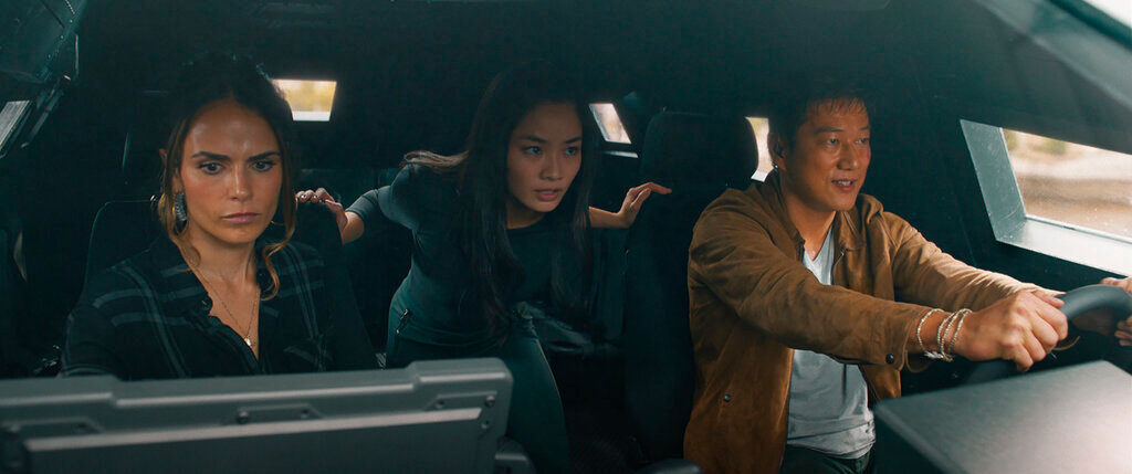 This image released by Universal Pictures shows Jordana Brewster, from left, Anna Sawai and Sung Kang in a scene from "F9: The Fast Saga." (Universal Pictures via AP)