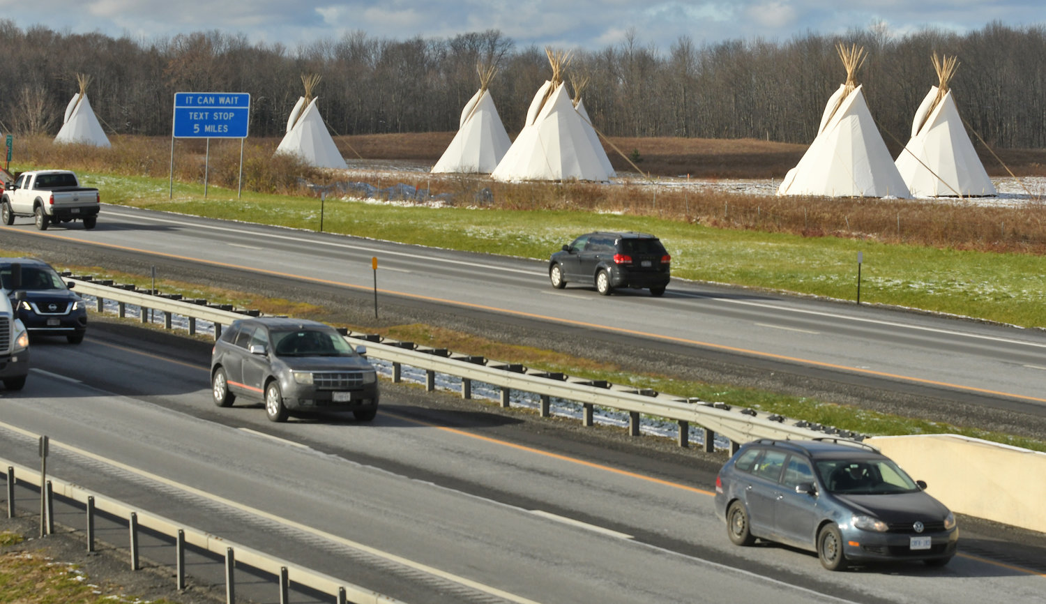 PEACE PASSAGE - Comprised of seven illuminated tipis located on the land of the Oneida Indian Nation just before Exit 33 of I-90, the Peace Passage will take place during the holidays.  The Oneida Indian Nation chose the tipi as the central image of the Peace Passage to recognize both these Western tribal nations and the collective challenges of Native American peoples.  While the Oneidas and other Iroquois tribes lived in longhouses, not tipis, the tipi is a universally recognized symbol of Native American identity.  Busy east and westbound traffic on the NY State Thruway with giant teepees on the north side of the crossing before the Verona exit westbound.