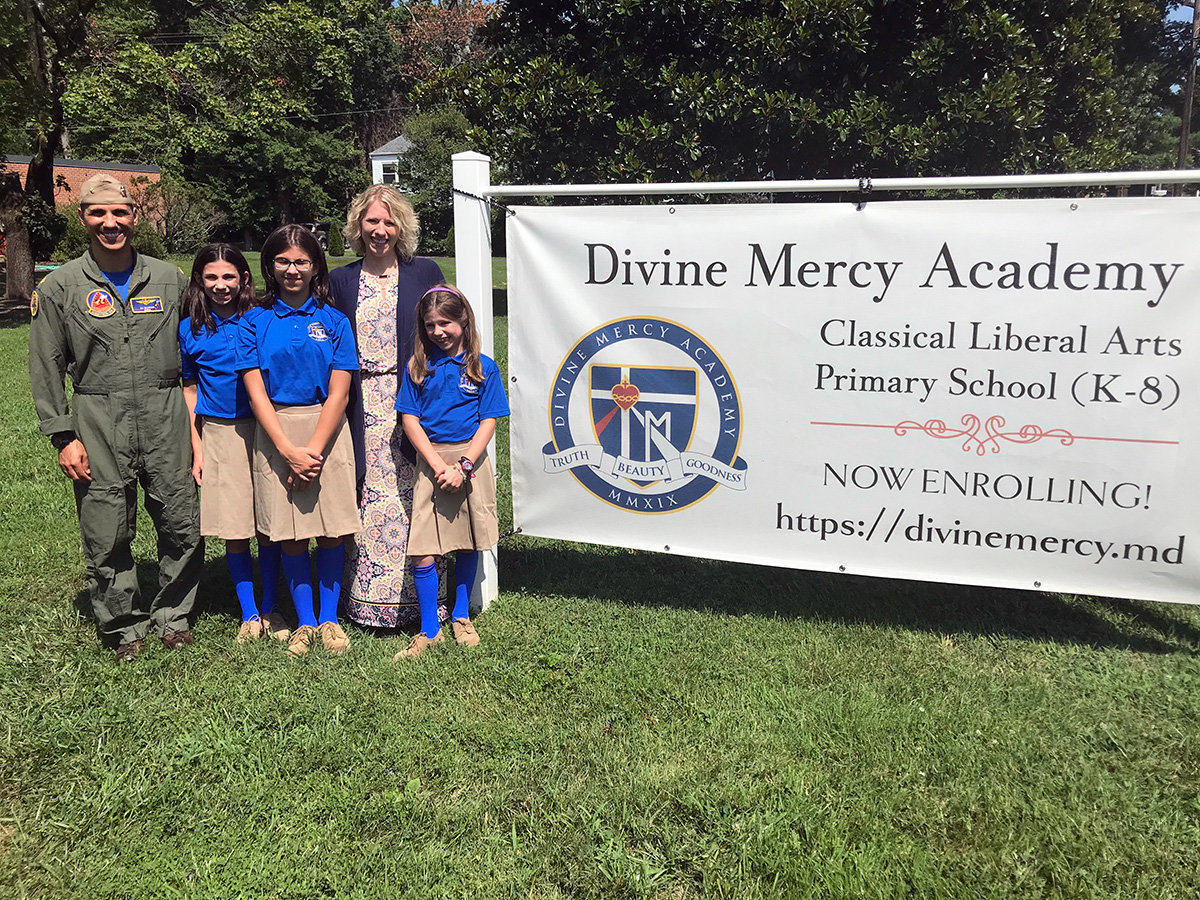 (L-R) Lieutenant Commander Ali Ghaffari, daughter Kaelyn Ghaffari, daughter Reyna Ghaffari, wife Mary Ghaffari and daughter Natalie Ghaffari posed in front of the Divine Mercy Academy, located at 400 Benfield Road in Severna Park.