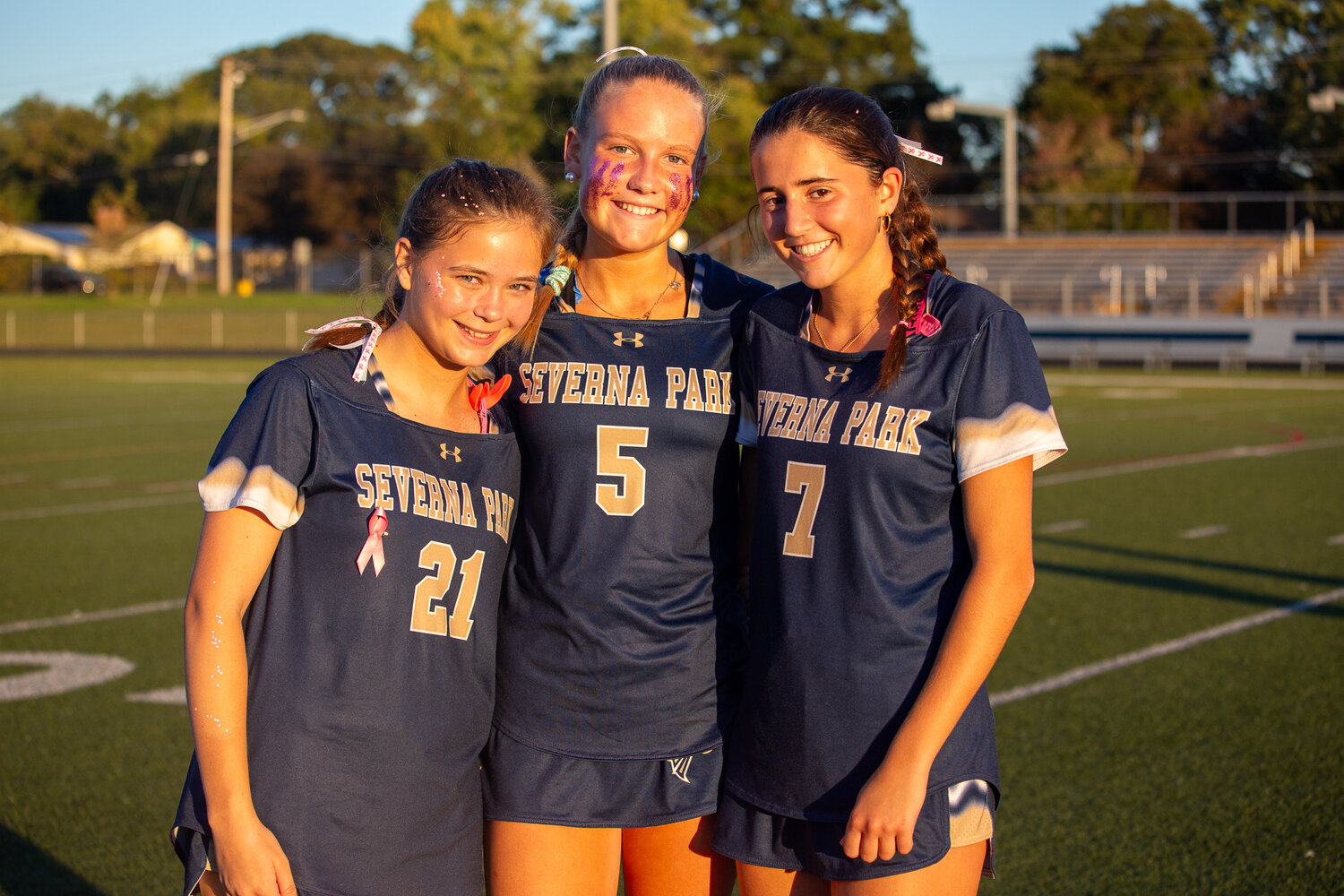 (L-R) Addison Tetrault, Millie Evans and Elle LaBrier wore pink socks, glitter and other accessories to honor their moms on October 9.